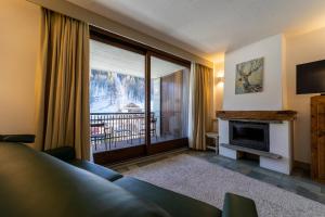 a living room with a couch and a fireplace at Alpesmith - Bike & Ski apartments in Bardonecchia