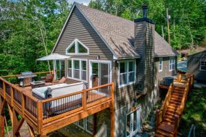 a home with a deck with a hot tub at Lessons from Mars in Banner Elk