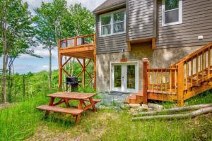 a house with a deck and a picnic table at Lessons from Mars in Banner Elk