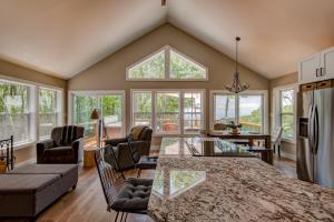 a kitchen and living room with a table and chairs at Lessons from Mars in Banner Elk