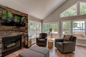 a living room with a fireplace and a flat screen tv at Lessons from Mars in Banner Elk