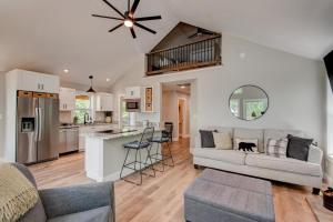 a living room with a couch and a kitchen at Lessons from Mars in Banner Elk
