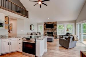 a kitchen with a stove and a living room at Lessons from Mars in Banner Elk