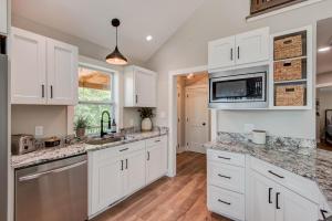 a kitchen with white cabinets and granite counter tops at Lessons from Mars in Banner Elk