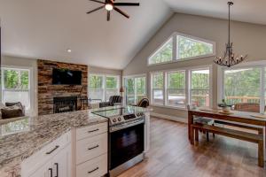a kitchen with a stove and a dining room with a table at Lessons from Mars in Banner Elk