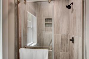 a bathroom with a shower with a glass door at Lessons from Mars in Banner Elk +37 photos