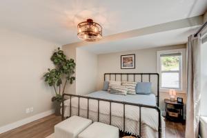 a bedroom with a bed and a chair and a window at Lessons from Mars in Banner Elk
