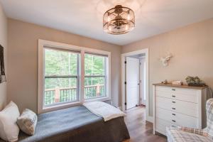 a bedroom with a window and a bed and a dresser at Lessons from Mars in Banner Elk