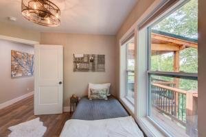 a room with a bed and a large window at Lessons from Mars in Banner Elk