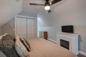 a bedroom with a bed with a fireplace and a flat screen tv at Lessons from Mars in Banner Elk