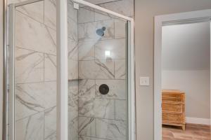 a shower with a glass door in a bathroom at Lessons from Mars in Banner Elk