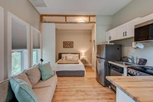 a living room with a couch and a kitchen at Lessons from Mars in Banner Elk