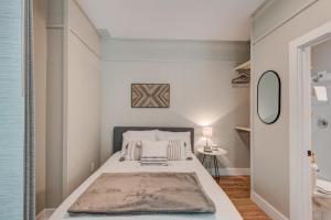 a small bedroom with a bed and a mirror at Lessons from Mars in Banner Elk