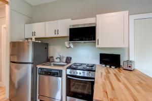 a kitchen with a stainless steel stove and white cabinets at Lessons from Mars in Banner Elk