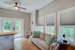 a living room with a couch and some windows at Lessons from Mars in Banner Elk