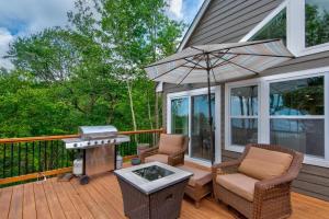 a grill and chairs on a deck with a grill at Lessons from Mars in Banner Elk