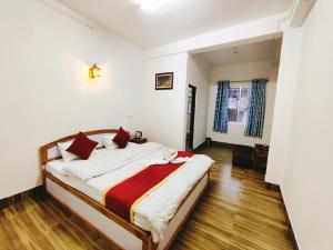 Postel nebo postele na pokoji v ubytování Jain Homestay