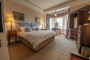 a bedroom with a large bed and a window at Upper Helmsley Hall 20 in Upper Helmsley