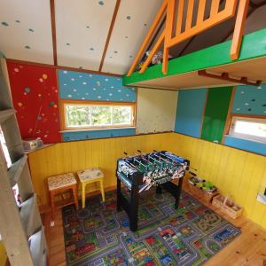 a childrens room with a bunk bed and a ladder at Omakoda in Vanamõisa