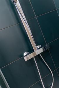 a shower head in a bathroom with a hose at Coppergate Mews Grimsby No.5 - 1 bed, 1 bath, 1st floor apartment in Grimsby