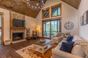 a living room with a couch and a fireplace at Sip Sip Hooray at Eagles Nest in Elk Park