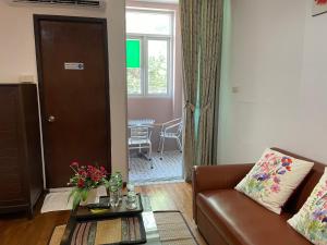 a living room with a couch and a table at Nawaporn Place in Phuket Town