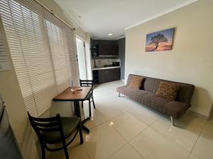 sala de estar con sofá y mesa en Suite Junior Urdesa Central., en Guayaquil