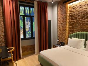 a bedroom with a bed and a brick wall at RUZ Hotels in Istanbul +45 photos