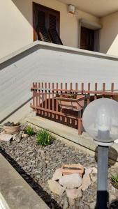 a bench in a yard with a table and a porch at Balo’s home in Venturina Terme