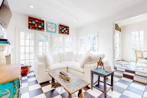 a living room with a white couch and a table at Magic in Millcreek in Millcreek