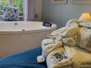 uma casa de banho com uma banheira e uma toalha em Pousada Do Conde em Campos do Jordão