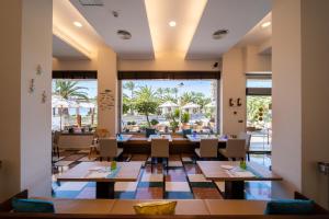 a restaurant with tables and chairs and a view of the ocean at La Sort Boutique Hotel in Moraira