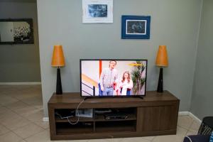 TV de pantalla plana en la parte superior de una mesa en House Samaika en Maun
