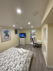 a bedroom with a bed and a desk and a television at Beautiful Unit in Nepean Ottawa in Ottawa