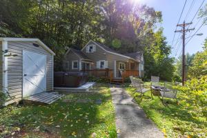 a house with a garage in the yard at Hot Toddy Cottage in Banner Elk
