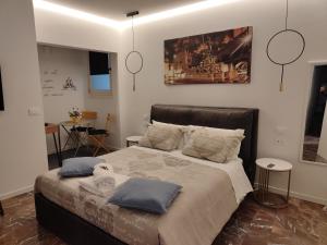 a bedroom with a large bed with blue pillows at Residenza Rialto in Bologna