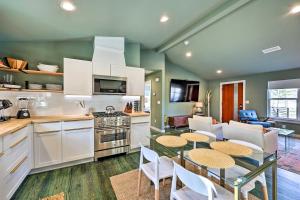 a kitchen and living room with a table and chairs at Modern Bentonville Home Mountain Bikers Paradise in Bentonville