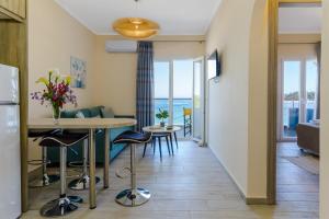 a kitchen and living room with a table and chairs at BigBlue luxury apartments in Póros Kefalonias