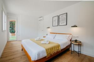 a bedroom with a large bed with white walls at tuGuest Carretera de la Sierra Apartment in Granada