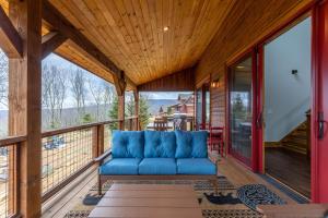 a blue couch on the porch of a house at Neverending Story at Eagles Nest in Banner Elk