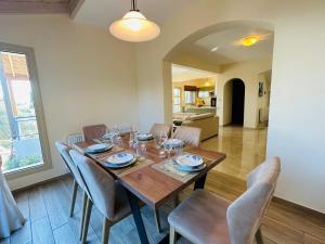 a dining room with a wooden table and chairs at Beach Villa Elena in Polis Chrysochous