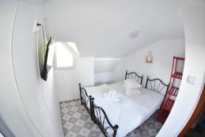 a bedroom with a bed in a white room at Piovra in Vama Veche