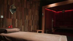 a bedroom with a bed with a red light at H&ocirc;tel Maison Pavlov in Le Bouscat