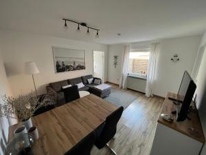 a living room with a table and a couch at Insel Koje 1 in Fehmarn