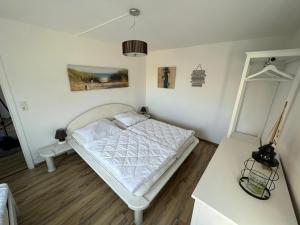 a bedroom with a white bed in a room at Insel Koje 1 in Fehmarn