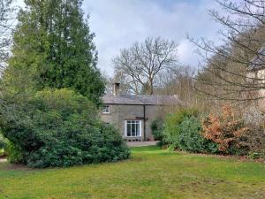 CanonbieにあるThe Coach House, Canonbieの木の植わる庭の古い石造りの家