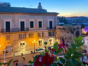 a view of a building in a city at dusk at Palazzo Florio Boutique Residence in Vasto