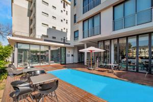 an image of a swimming pool in a building at One Hyde Park Apartments Sandton in Johannesburg