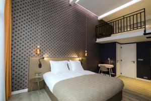 a hotel room with a bed and a staircase at Valerius Boutique Hotel in Wormer