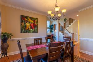 a dining room with a table and chairs and a painting on the wall at Pisgah Retreat at Linville Falls in Linville Falls